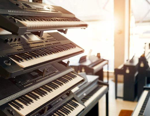 Close-up of synthesizers and midi keyboards in a musical instrument store. Lots of different keyboard instruments for sale. Hobbies and recreation.